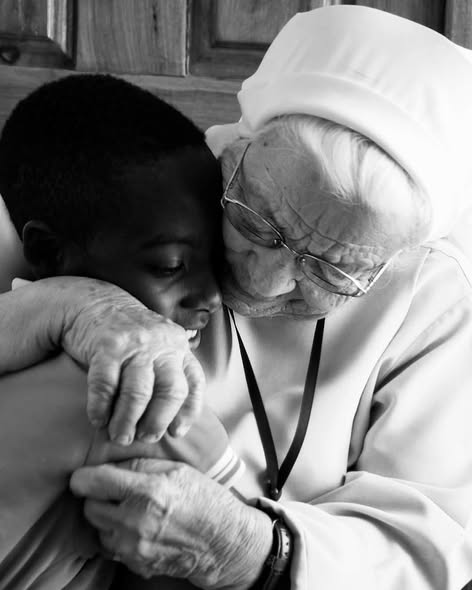 Sister Jolanta embracing a child