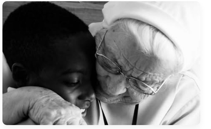 Sister Jolanta embracing a child